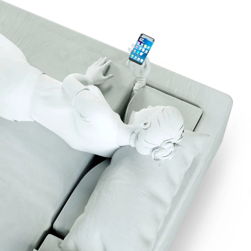 3D rendering of slide sleeper comfortably holding a smart phone while her arm, hand and wrist are being ergonomically supported by the Comfort Channel of the SONU mattress - view from above.